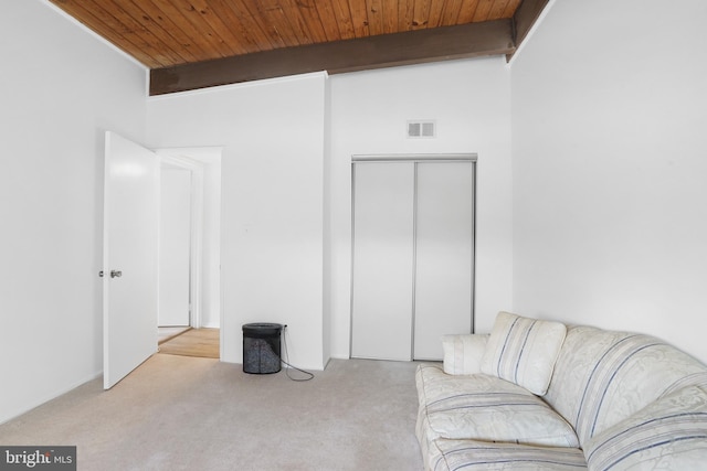 living room with beam ceiling, light carpet, and wooden ceiling