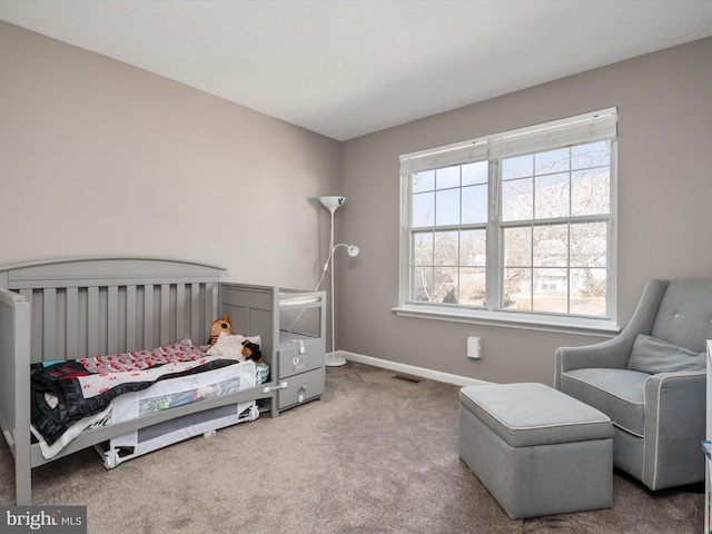 carpeted bedroom featuring baseboards and visible vents