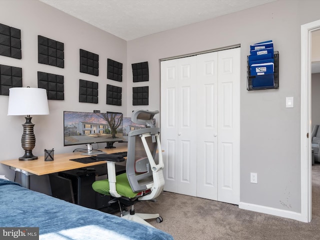 office featuring carpet flooring, a textured ceiling, and baseboards