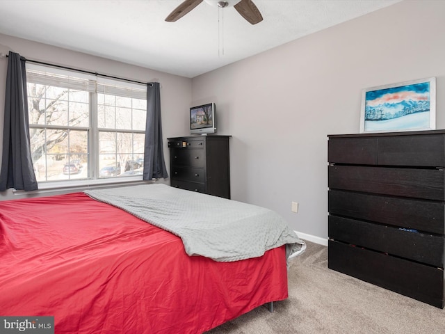 bedroom with light carpet, a ceiling fan, and baseboards