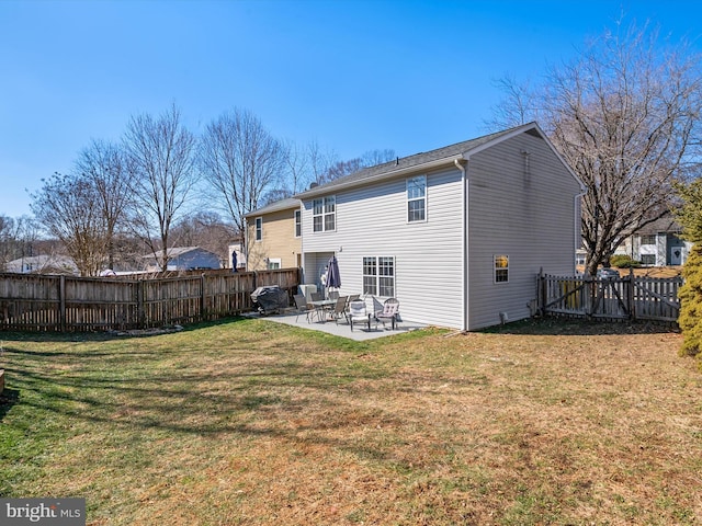 back of house featuring a yard, a patio area, and a fenced backyard