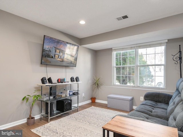 living room with recessed lighting, wood finished floors, visible vents, and baseboards