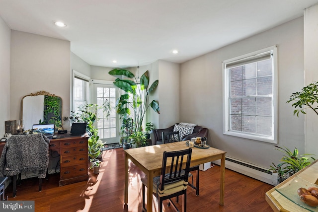 dining space featuring dark hardwood / wood-style floors and a baseboard heating unit