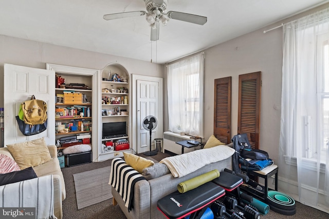 living room with radiator, carpet floors, and ceiling fan