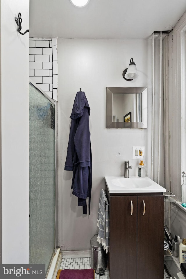 bathroom with vanity and a shower with door