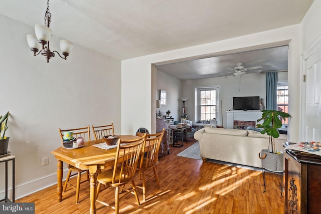 dining space featuring wood-type flooring and ceiling fan