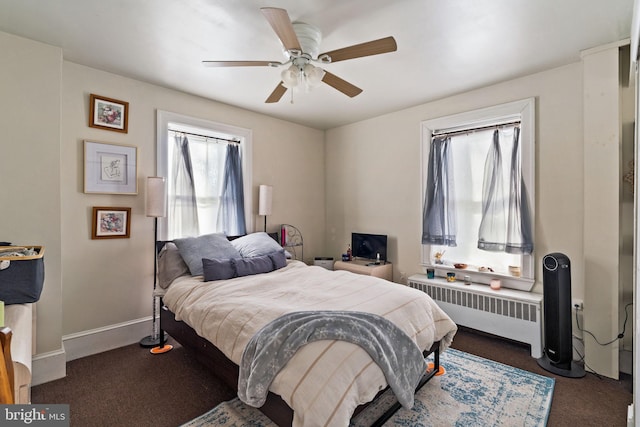 carpeted bedroom featuring radiator and ceiling fan