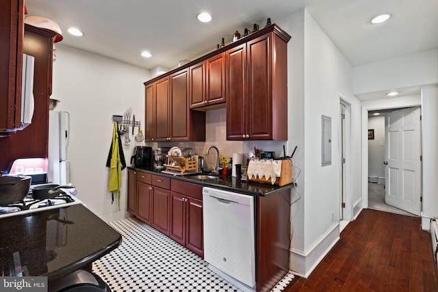 kitchen featuring hardwood / wood-style floors, tasteful backsplash, sink, electric panel, and white appliances