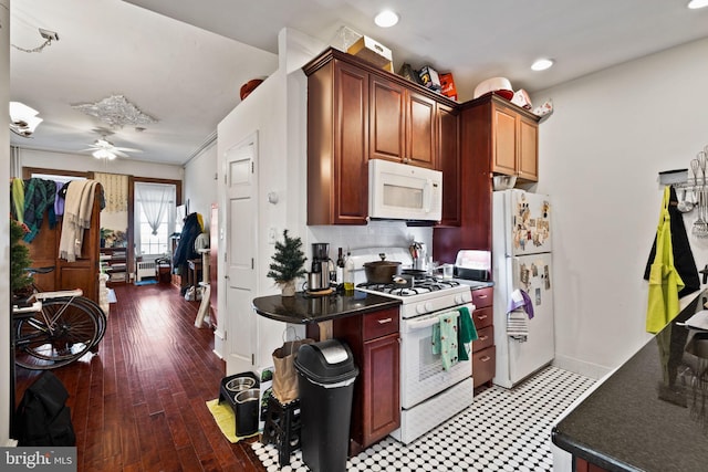 kitchen featuring hardwood / wood-style floors, white appliances, decorative backsplash, and ceiling fan