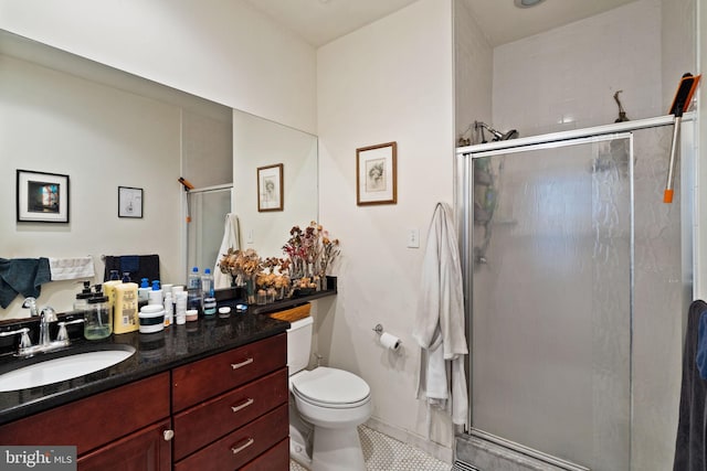 bathroom with walk in shower, tile patterned floors, vanity, and toilet