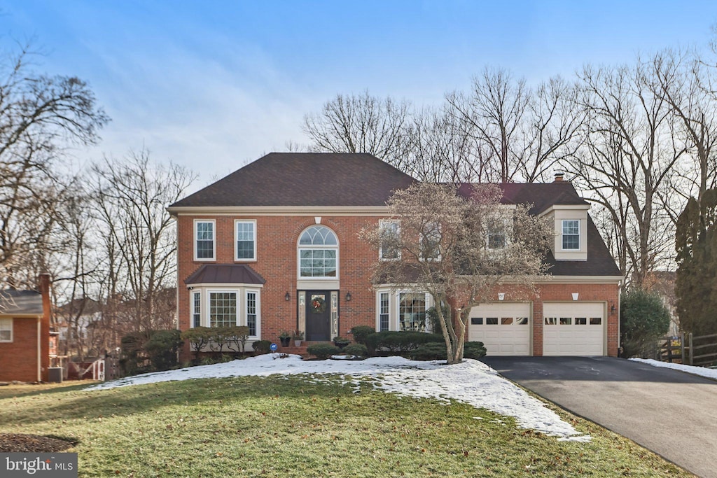 view of front of home with a garage and a front lawn