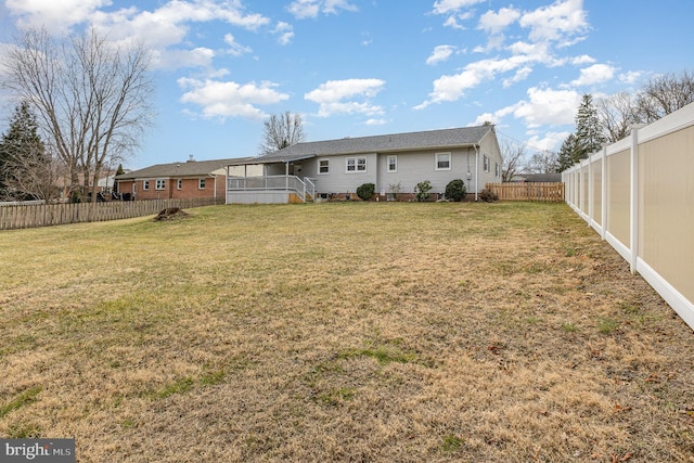 rear view of house with a lawn