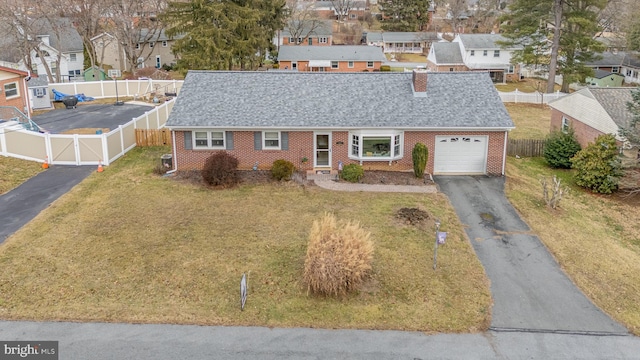 view of front facade with a garage and a front yard