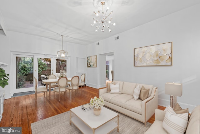 living room with a chandelier and light hardwood / wood-style flooring