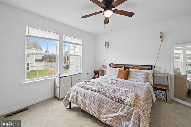 bedroom with light colored carpet and ceiling fan