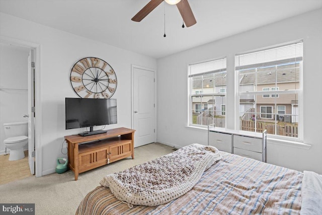 bedroom with light colored carpet and ensuite bath