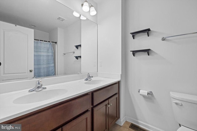 bathroom with vanity, toilet, and walk in shower