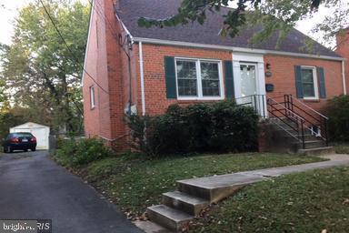 view of front of house featuring an outbuilding, a garage, and a front yard