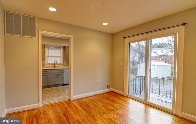 interior space with sink and light wood-type flooring