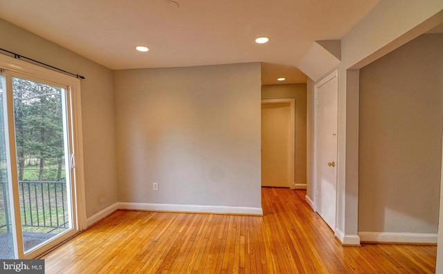 empty room featuring a healthy amount of sunlight and light hardwood / wood-style floors