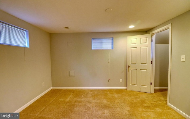 basement featuring light colored carpet