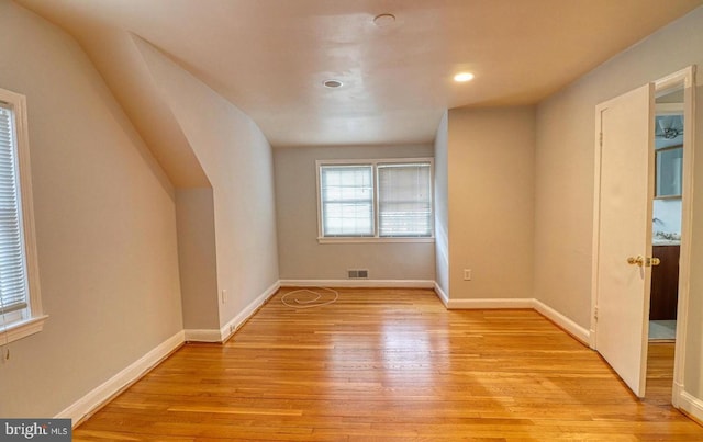 additional living space featuring light wood-type flooring