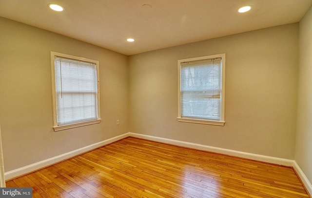 unfurnished room featuring a wealth of natural light and light hardwood / wood-style floors