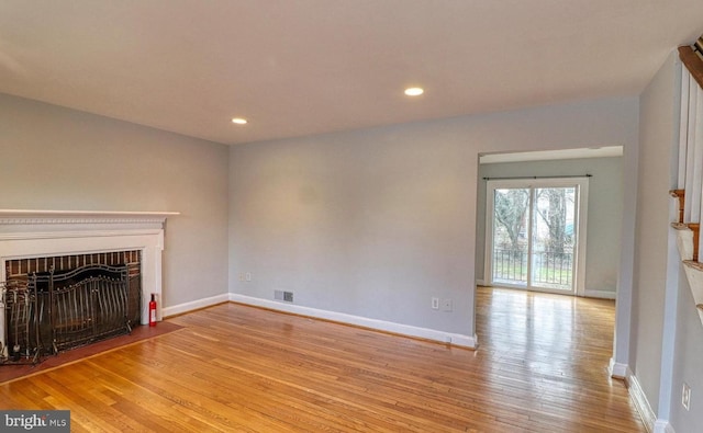 unfurnished living room with light wood-type flooring