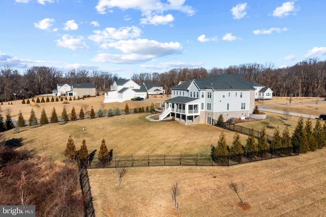 exterior space with a lawn, a sunroom, and a rural view