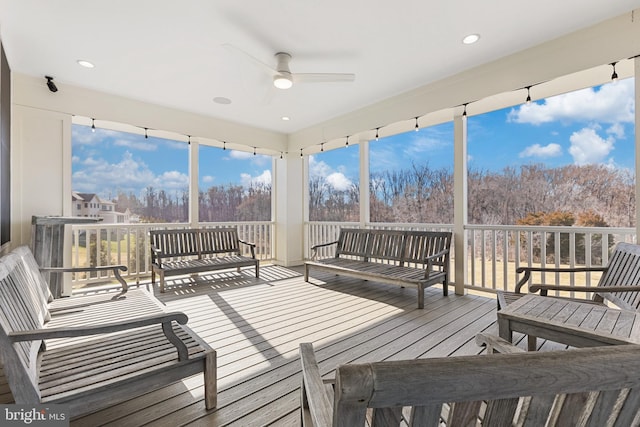 sunroom / solarium featuring ceiling fan