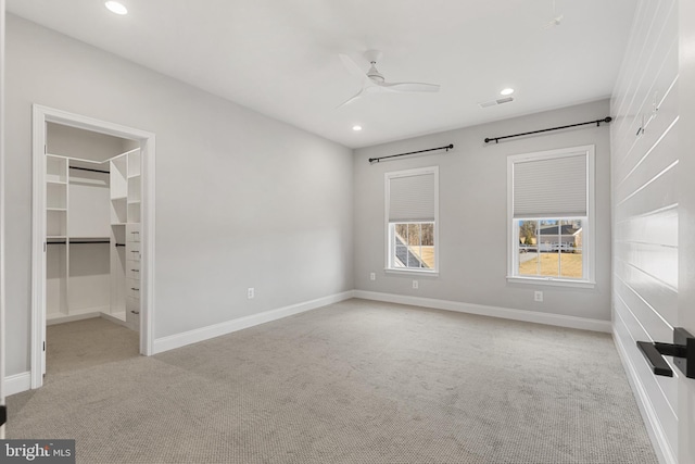 unfurnished bedroom with light colored carpet and ceiling fan