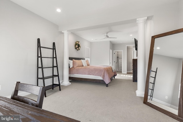 bedroom with decorative columns and carpet flooring