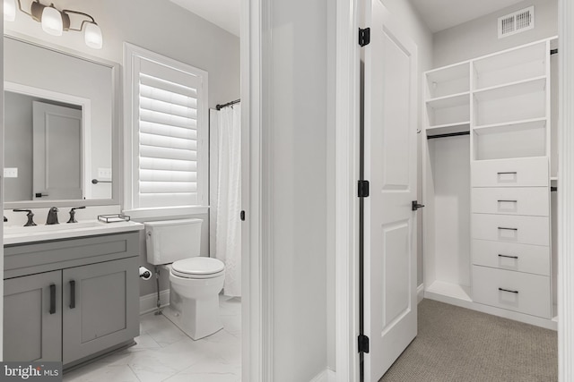 bathroom featuring vanity and toilet