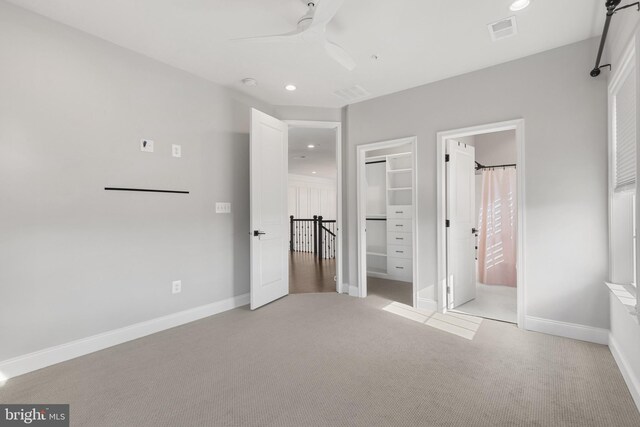 unfurnished bedroom with light colored carpet and ceiling fan