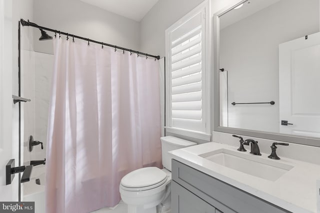 full bathroom with vanity, toilet, and shower / bath combo with shower curtain