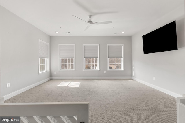 unfurnished living room featuring light carpet and ceiling fan