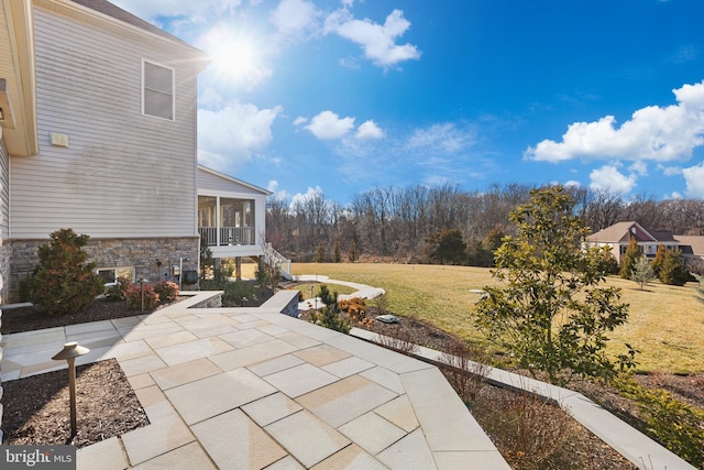 view of patio featuring a sunroom