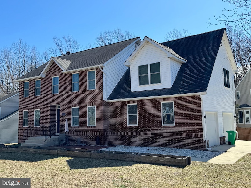 view of front of home featuring brick siding, a shingled roof, a garage, driveway, and a front lawn