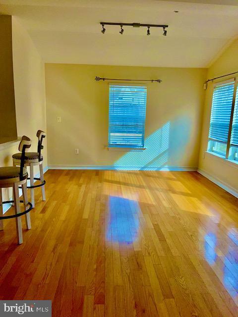 living room featuring light hardwood / wood-style floors and vaulted ceiling