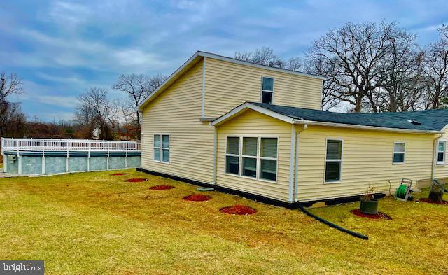 back of property with a lawn