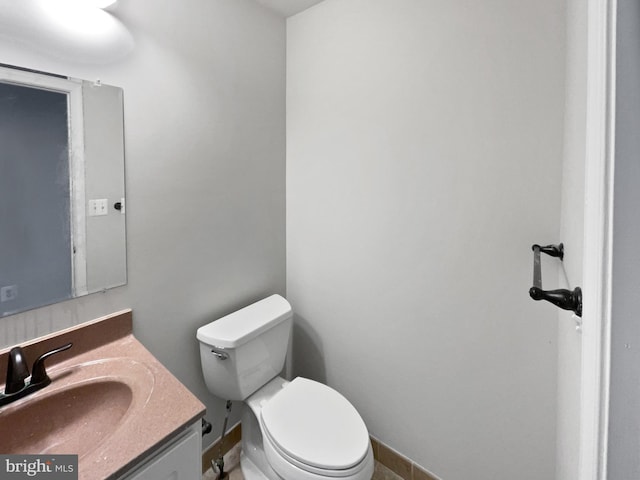 half bathroom with vanity and toilet