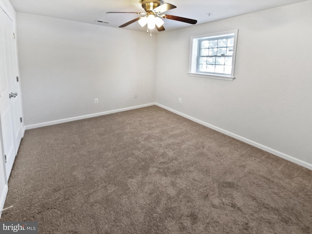 spare room with baseboards, visible vents, ceiling fan, and carpet flooring