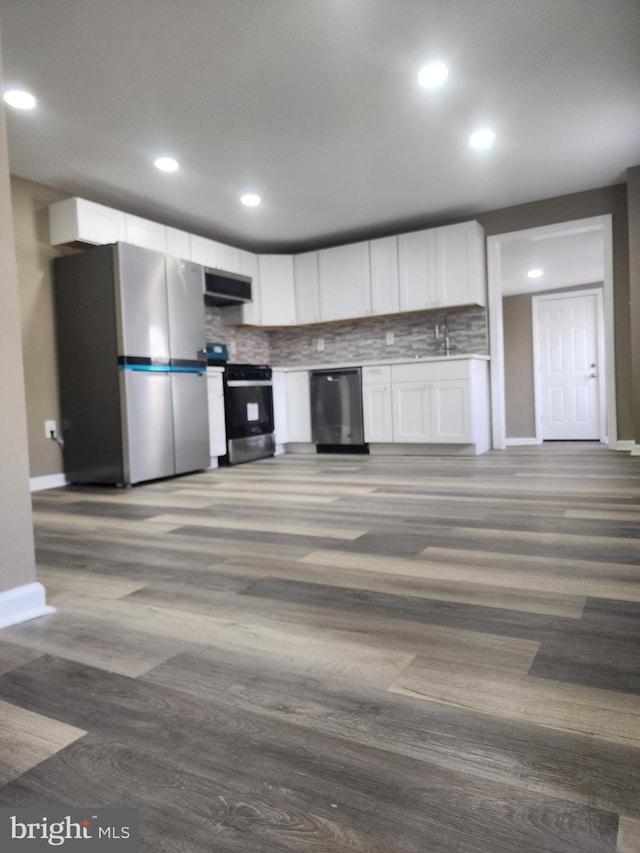 kitchen with white cabinetry, extractor fan, tasteful backsplash, and appliances with stainless steel finishes