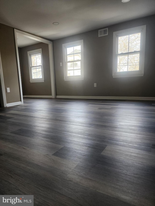 spare room featuring dark hardwood / wood-style flooring