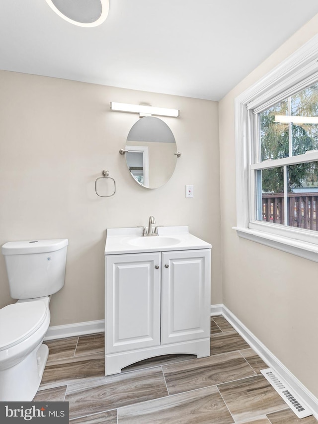 bathroom featuring vanity and toilet