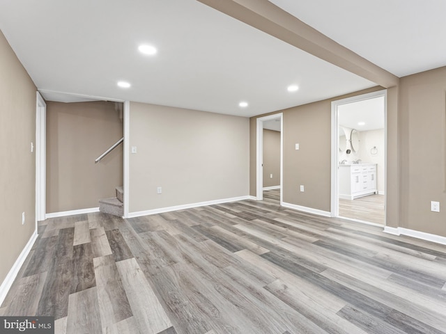 basement with light hardwood / wood-style floors