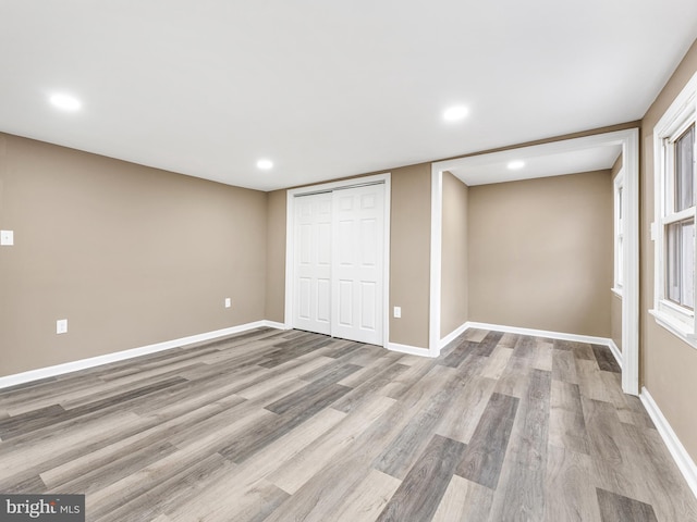 unfurnished bedroom featuring light hardwood / wood-style floors and a closet