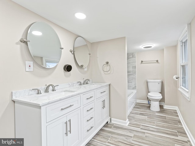 full bathroom featuring vanity, bathtub / shower combination, and toilet