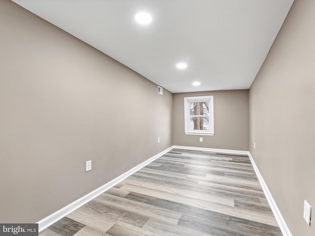 empty room with light hardwood / wood-style flooring