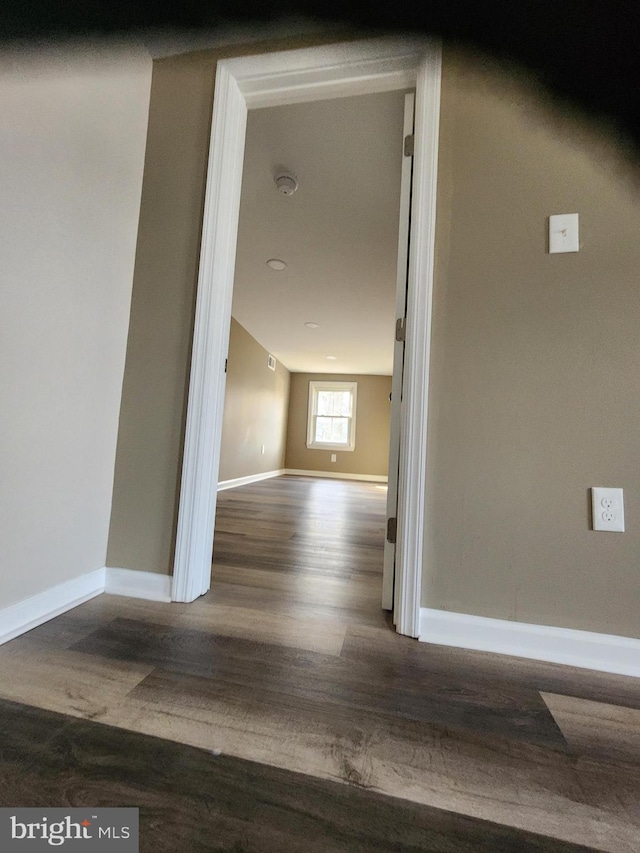 hallway with hardwood / wood-style flooring